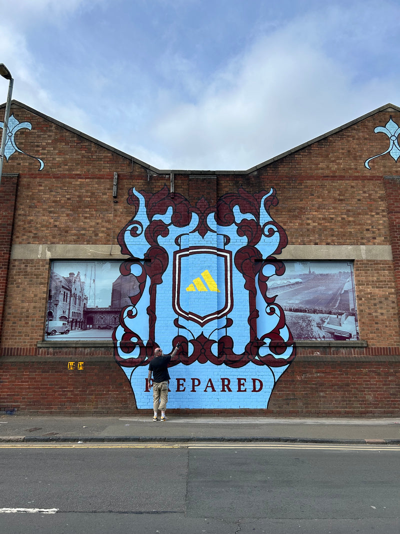 Decorative sign on a brick building with a blue sky background