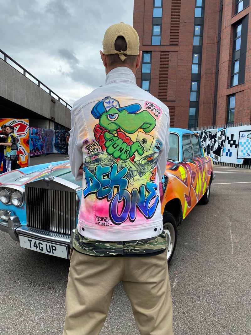 Person wearing a colorful jacket with cartoon design in an urban setting