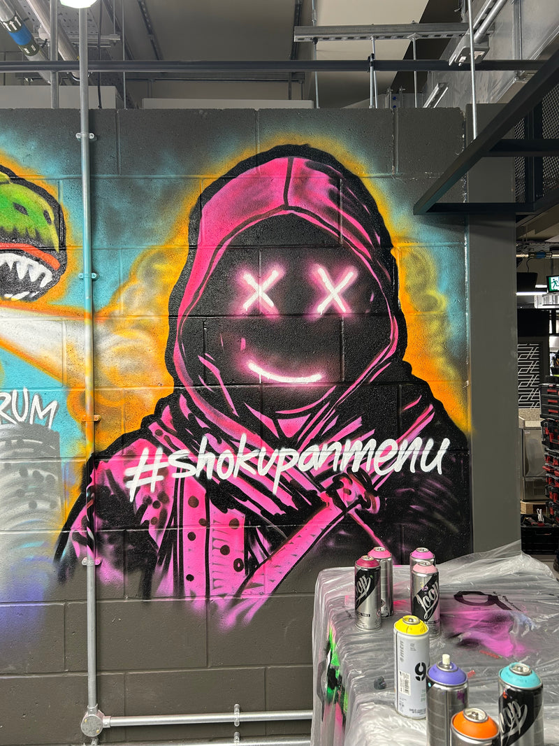 Graffiti-style artwork on a wall with colorful design and text.